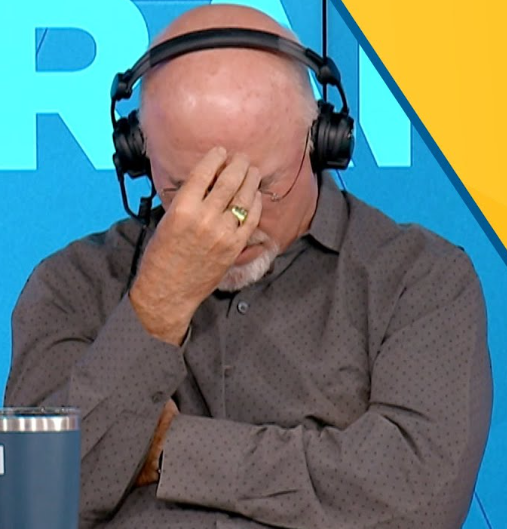 Bald man with a white beard and headphones covering his face with his hand in a radio studio