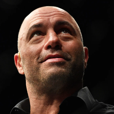 Close-up of Joe Rogan looking upward against a dark background